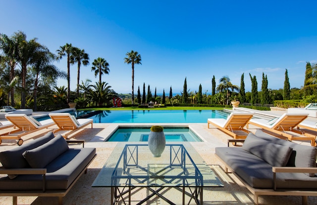 view of swimming pool featuring a patio, an outdoor living space, and an in ground hot tub