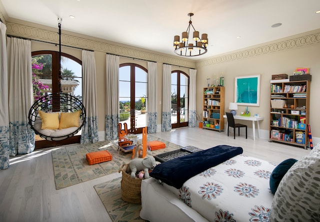 bedroom with french doors, an inviting chandelier, hardwood / wood-style flooring, and access to outside