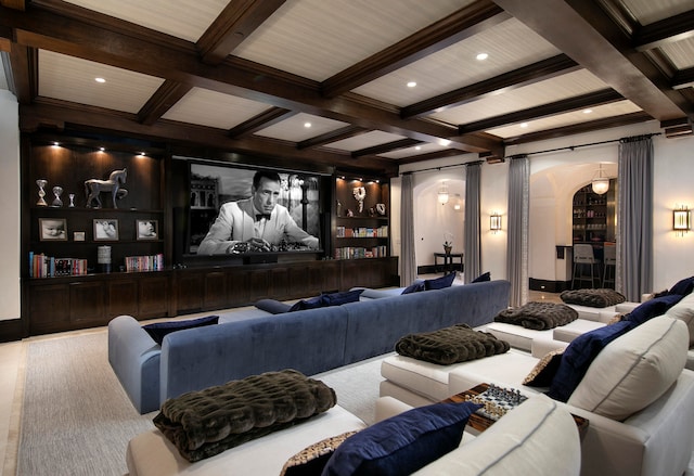 cinema room with beam ceiling, coffered ceiling, and built in shelves