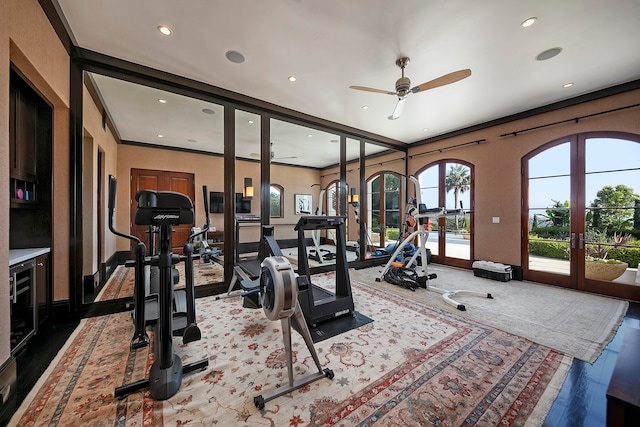 workout room featuring wood-type flooring, ceiling fan, crown molding, and french doors