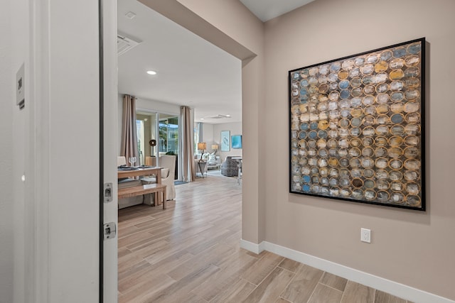 hall with light hardwood / wood-style floors