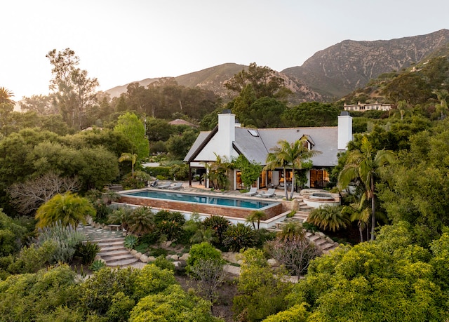 view of swimming pool featuring a mountain view and a patio