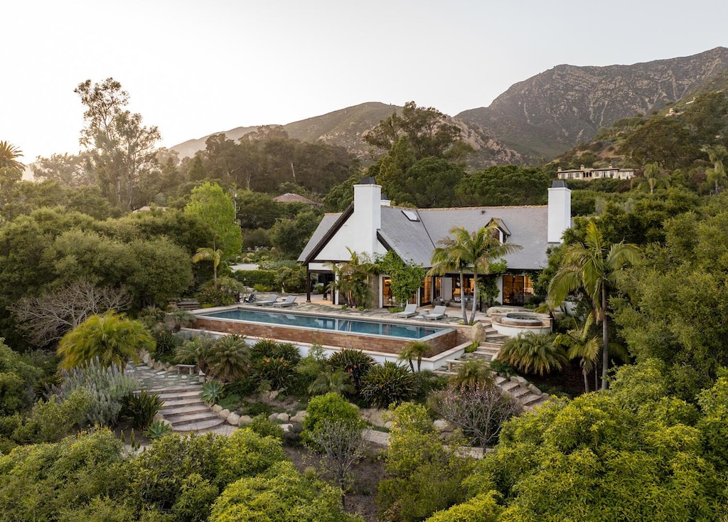 pool featuring a patio and a mountain view