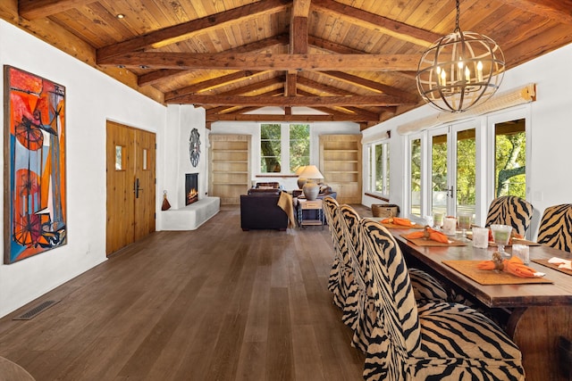 dining room featuring dark hardwood / wood-style flooring, a fireplace, a notable chandelier, wooden ceiling, and beam ceiling