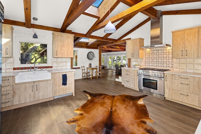 kitchen with decorative light fixtures, wall chimney exhaust hood, dark hardwood / wood-style flooring, and high end stainless steel range oven