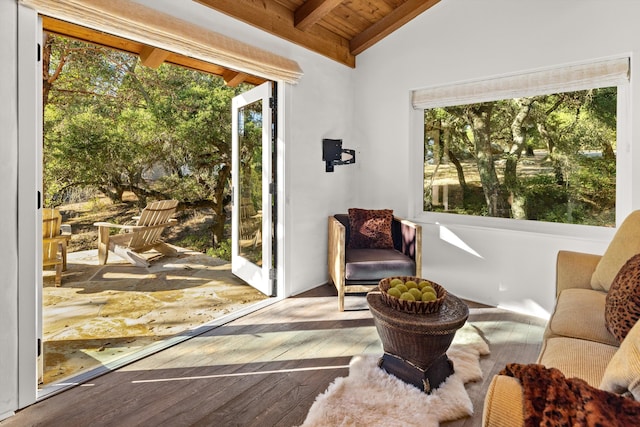 unfurnished room with vaulted ceiling with beams, hardwood / wood-style flooring, and wood ceiling