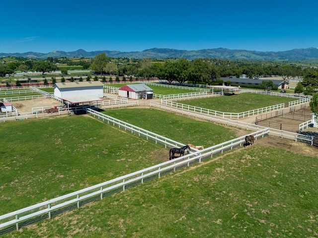 birds eye view of property featuring a mountain view and a rural view