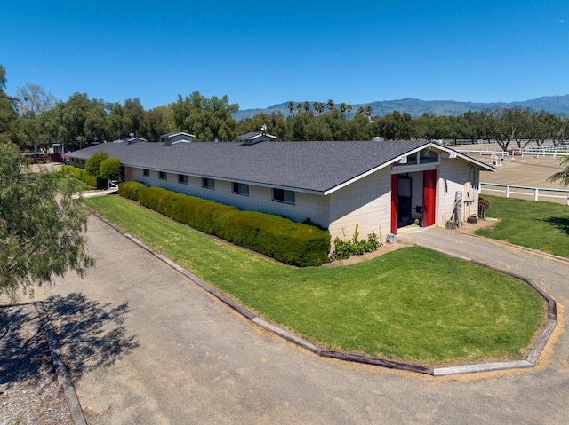 ranch-style house with a front lawn and a mountain view