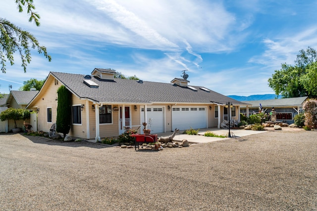 ranch-style home with a garage and a porch