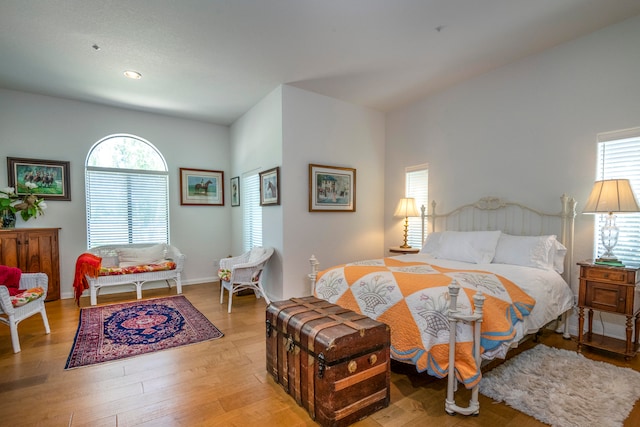 bedroom with wood-type flooring and multiple windows