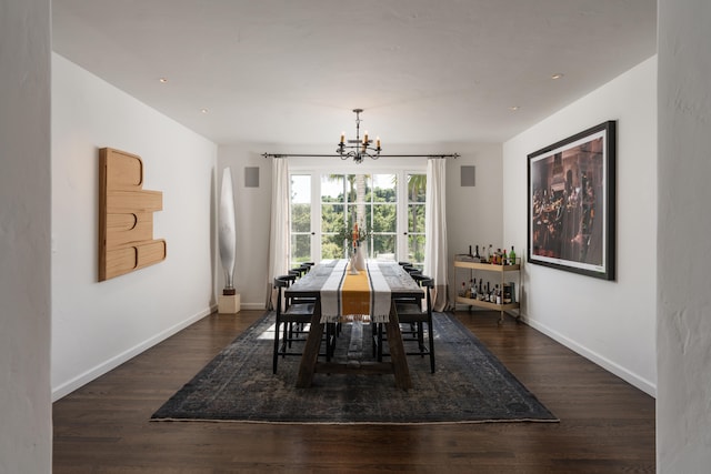 dining area featuring a notable chandelier and dark hardwood / wood-style floors