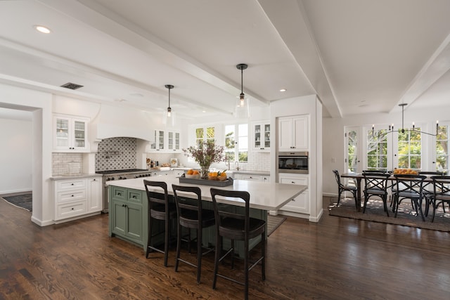 kitchen featuring tasteful backsplash, white cabinets, and a kitchen island