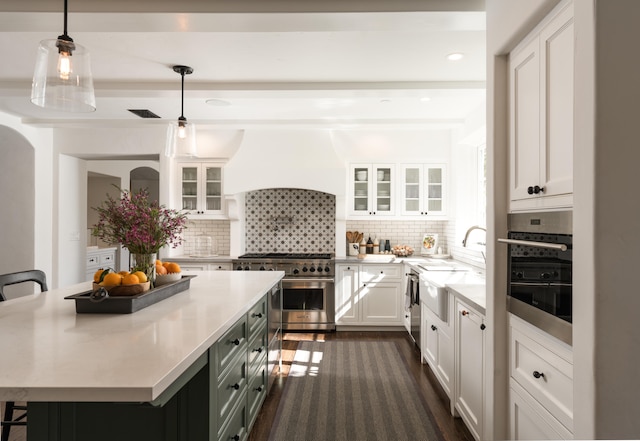 kitchen with backsplash, appliances with stainless steel finishes, and white cabinetry