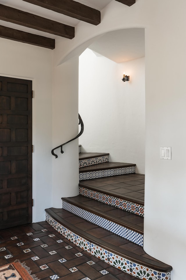 staircase with beam ceiling