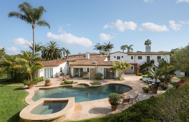 view of swimming pool featuring a patio area, french doors, and an in ground hot tub