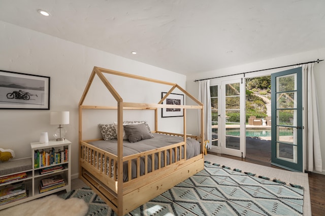 bedroom featuring access to outside, french doors, and hardwood / wood-style floors