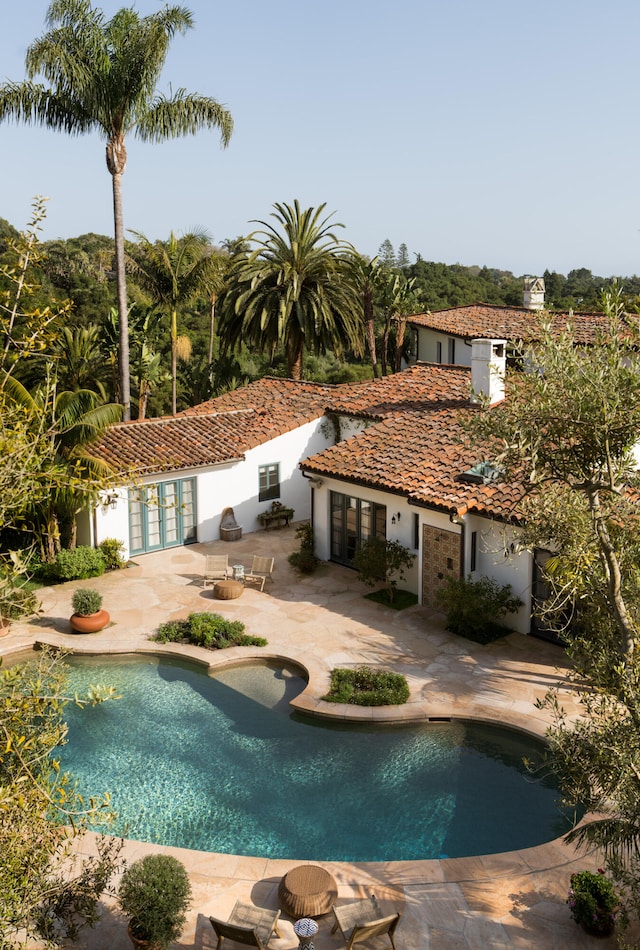 view of pool featuring a patio and french doors