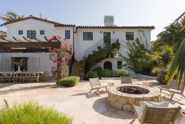 back of property featuring a patio, a pergola, and an outdoor fire pit