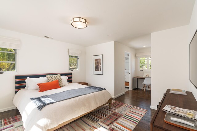 bedroom with dark hardwood / wood-style floors