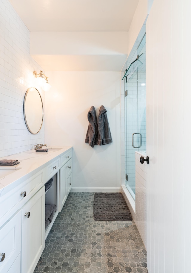 bathroom featuring tile floors, a shower with door, and vanity