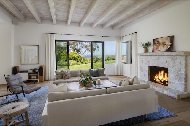 living room with beam ceiling, wood-type flooring, wood ceiling, and a fireplace