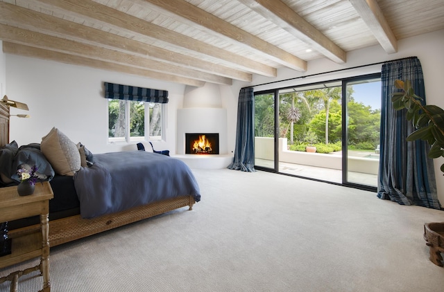 carpeted bedroom featuring wooden ceiling, access to exterior, a fireplace, and beamed ceiling