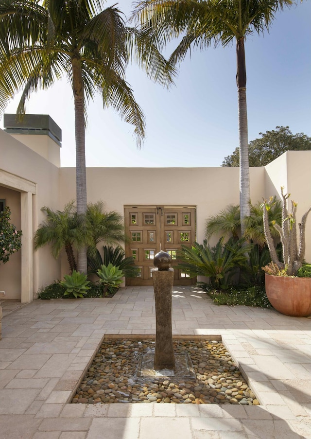 exterior space featuring fence and stucco siding