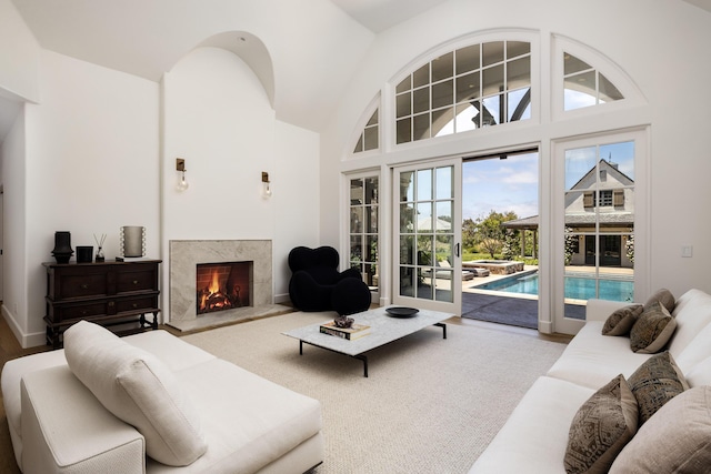 living room with a fireplace and a high ceiling