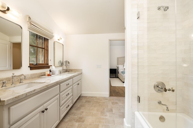 bathroom with shower / bath combination with glass door and vanity