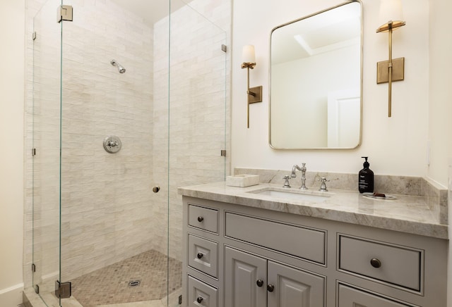 bathroom with vanity and a shower with door