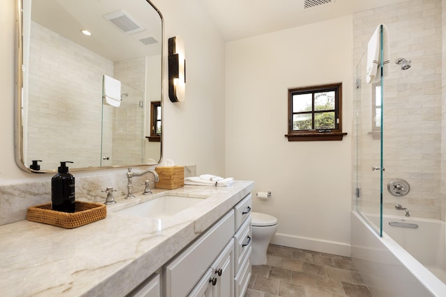 full bathroom featuring toilet, vanity, and tiled shower / bath