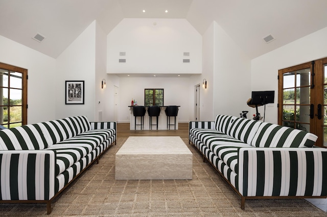 living room with high vaulted ceiling