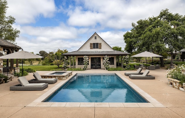 view of swimming pool featuring an outdoor hangout area, an in ground hot tub, a patio, and an outdoor structure