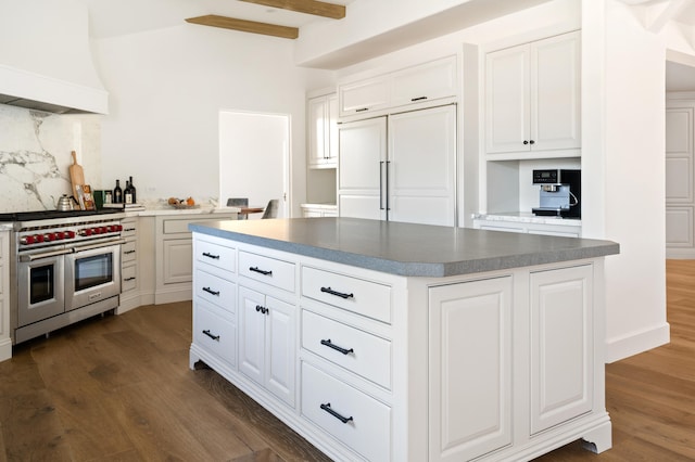 kitchen featuring dark wood-type flooring, beamed ceiling, premium range hood, white cabinets, and high end appliances