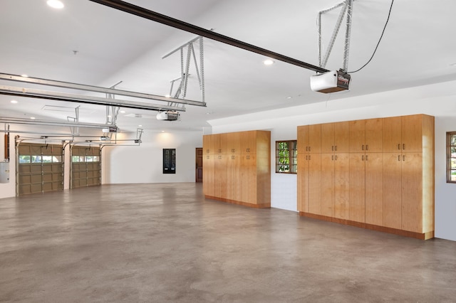 garage with electric panel and a garage door opener