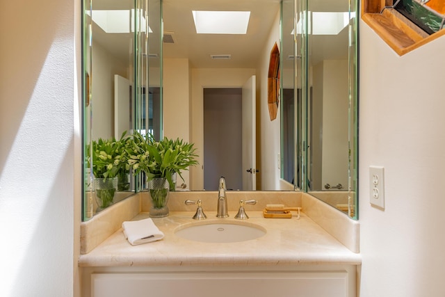 bathroom featuring vanity and a skylight