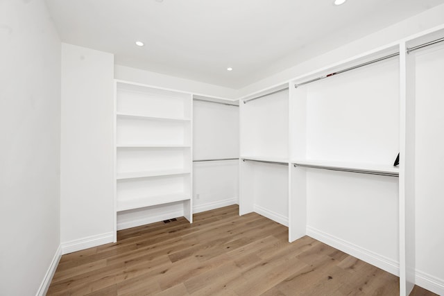 walk in closet featuring light hardwood / wood-style flooring