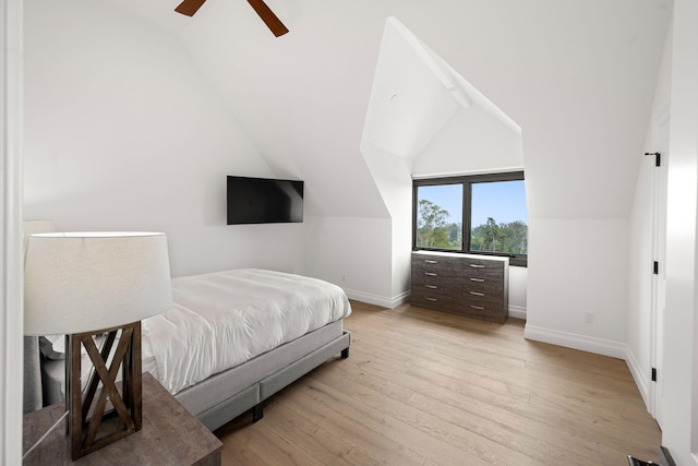 bedroom featuring ceiling fan, lofted ceiling, and light hardwood / wood-style flooring