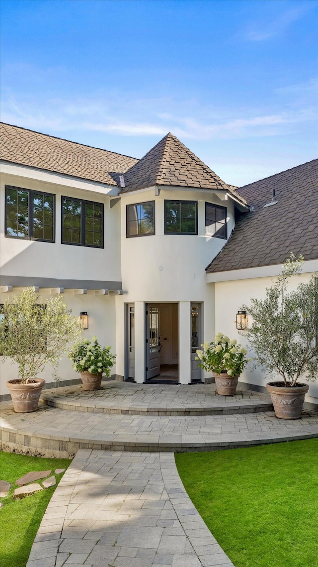 view of front of house with a patio area and a front yard