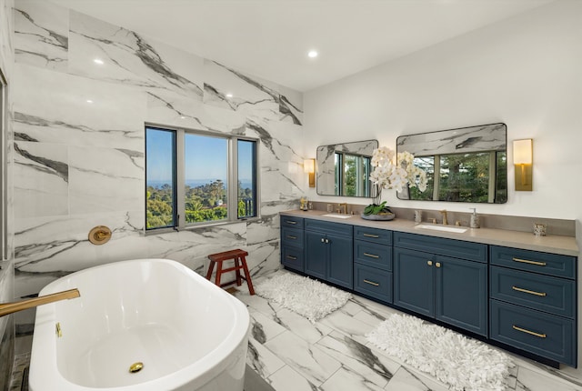 bathroom featuring vanity, a bathtub, and plenty of natural light