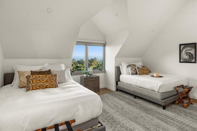 bedroom with hardwood / wood-style flooring and lofted ceiling