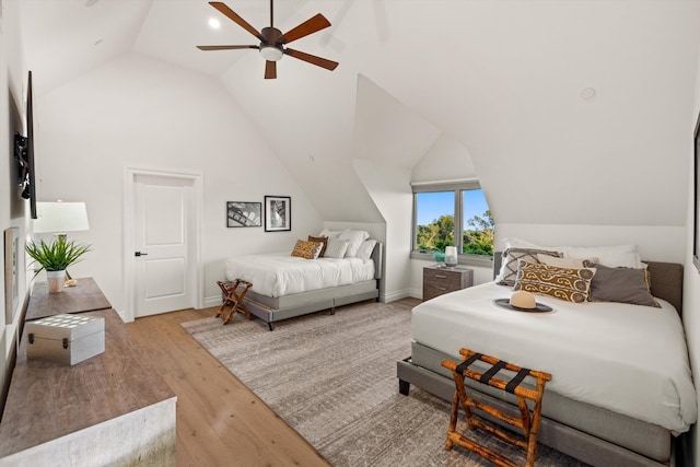 bedroom with vaulted ceiling, ceiling fan, and light hardwood / wood-style floors