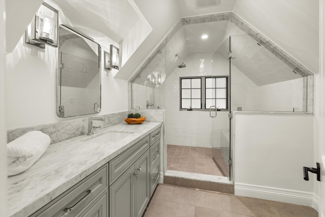 bathroom with tile patterned flooring, vanity, and walk in shower