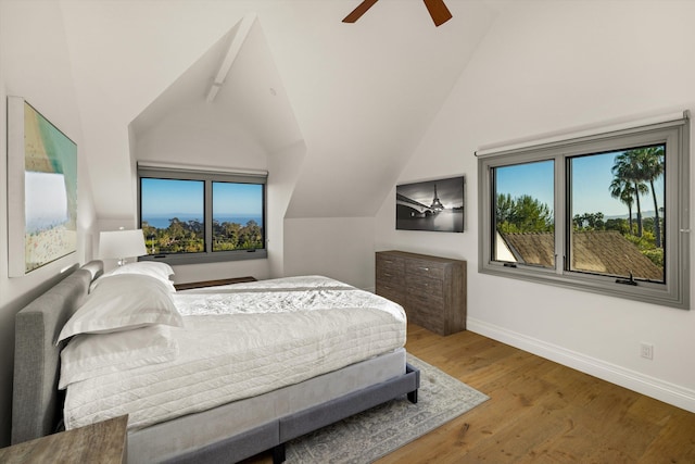 bedroom featuring ceiling fan, vaulted ceiling, and wood-type flooring