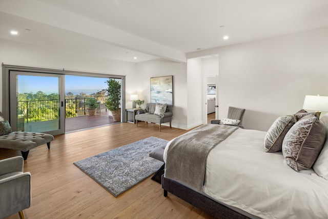 bedroom with access to exterior and light hardwood / wood-style flooring