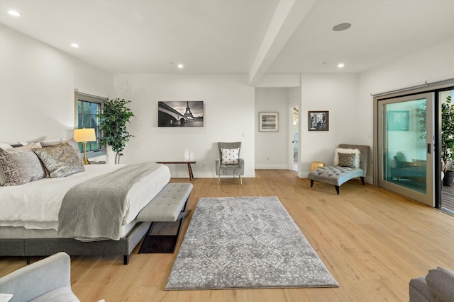 bedroom featuring multiple windows, access to exterior, and light hardwood / wood-style flooring