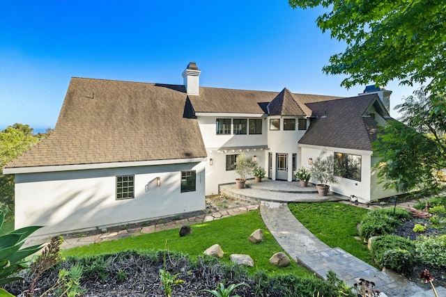 back of property featuring a yard and a patio area