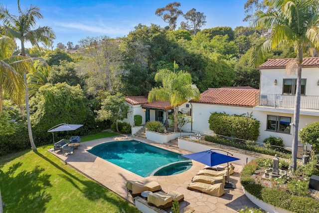 view of swimming pool featuring a patio area and a lawn