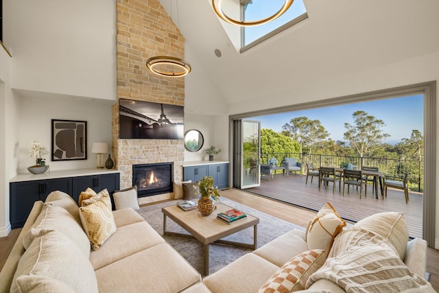 living room featuring a fireplace, wood-type flooring, and a healthy amount of sunlight