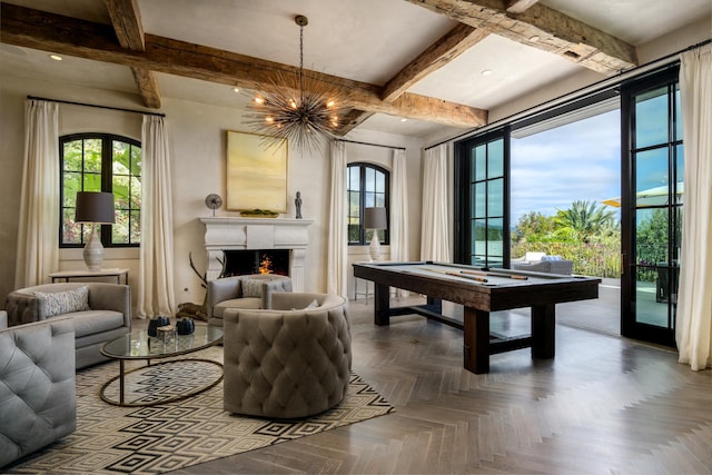 playroom with a lit fireplace, a chandelier, beam ceiling, and pool table